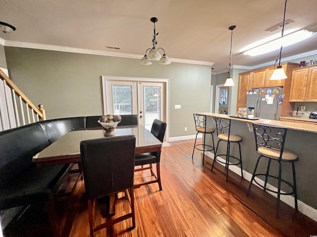 2347 Devine St, Georgetown, SC 29440 - dining room with crown molding, visible vents, french doors, and light wood finished floors