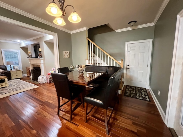 dining area with an inviting chandelier, ornamental molding, and hardwood / wood-style flooring