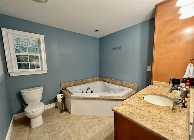 bathroom with vanity, toilet, and a tub