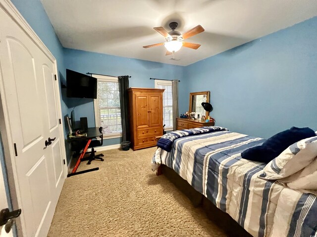 carpeted bedroom with ceiling fan