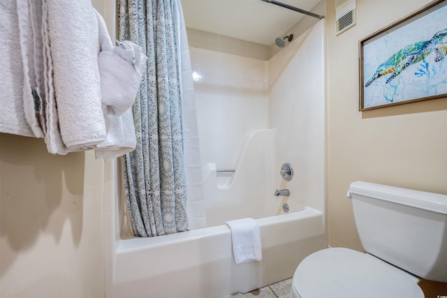 bathroom with tile patterned flooring, toilet, and shower / tub combo with curtain