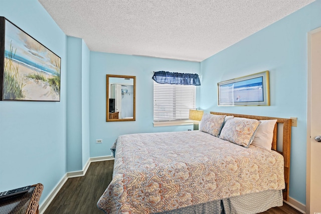 bedroom with dark hardwood / wood-style flooring and a textured ceiling