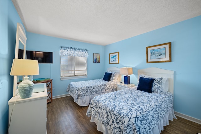 bedroom with a textured ceiling and dark wood-type flooring