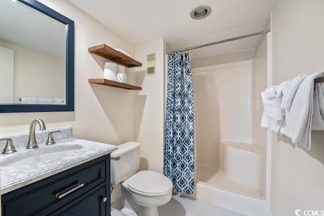 bathroom with vanity, toilet, and curtained shower