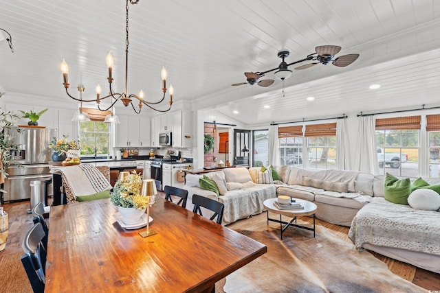 dining space featuring ornamental molding, ceiling fan with notable chandelier, light hardwood / wood-style floors, and a healthy amount of sunlight