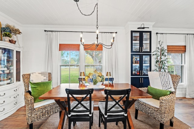 dining area featuring a chandelier, wood ceiling, ornamental molding, and wood-type flooring