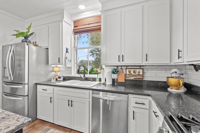 kitchen featuring white cabinetry, sink, ornamental molding, and stainless steel appliances