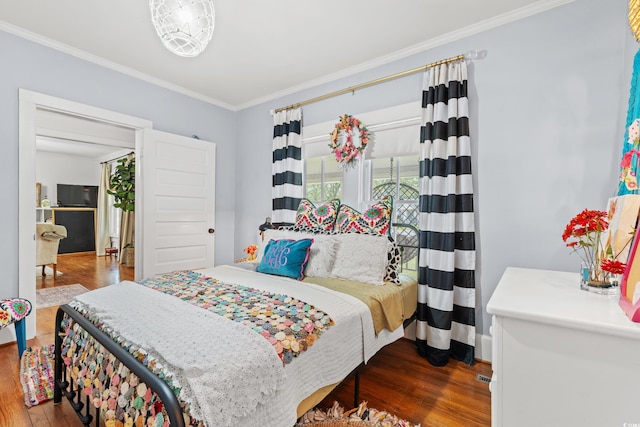 bedroom featuring ornamental molding and dark hardwood / wood-style floors