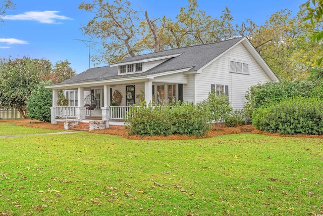 view of front facade with a front lawn and covered porch