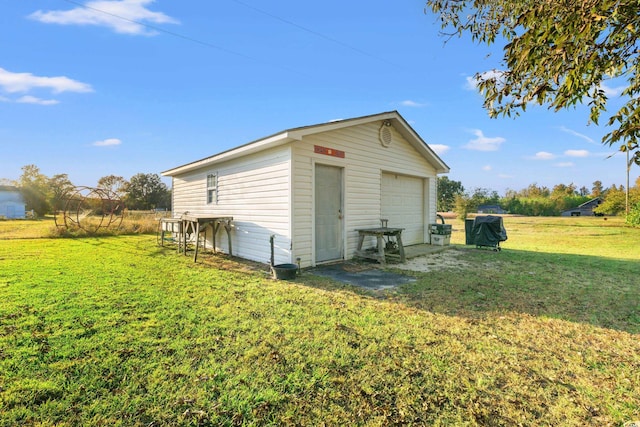 view of outbuilding featuring a garage and a lawn