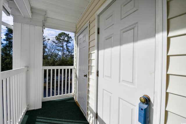 view of exterior entry featuring covered porch