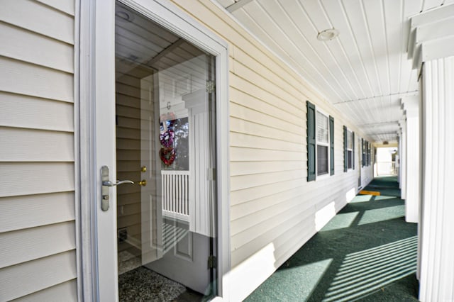 view of exterior entry featuring covered porch