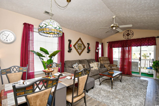 living room with a textured ceiling, ceiling fan, lofted ceiling, and hardwood / wood-style flooring