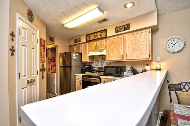 kitchen with kitchen peninsula, appliances with stainless steel finishes, and a textured ceiling