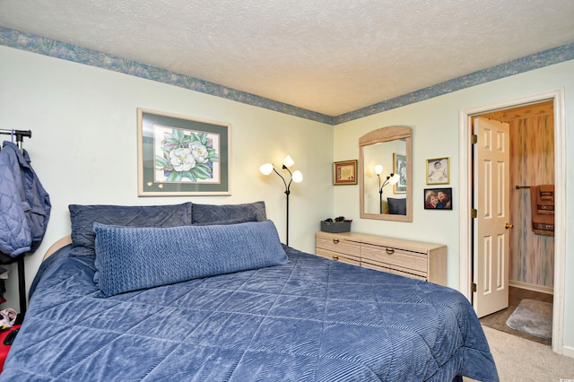 bedroom with carpet floors and a textured ceiling