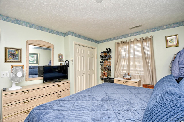 bedroom featuring a textured ceiling and a closet