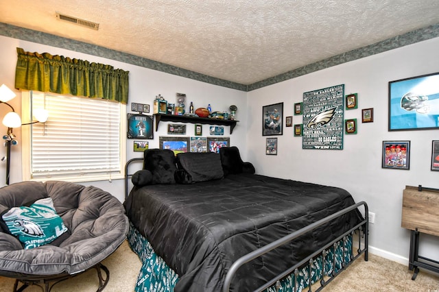 bedroom featuring carpet and a textured ceiling