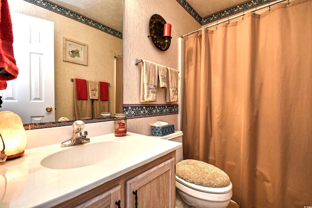 bathroom featuring vanity, a textured ceiling, and toilet