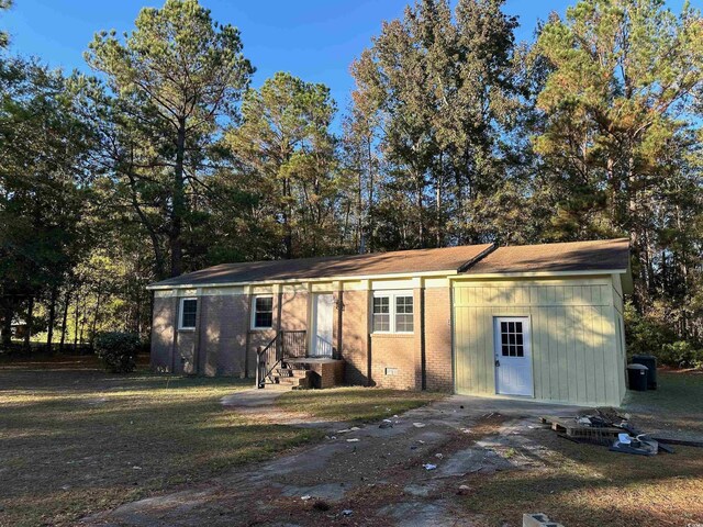 rear view of property with central AC unit