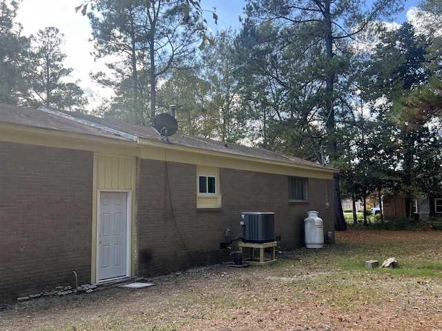 back of property featuring central air condition unit