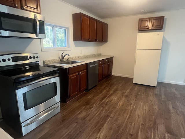 kitchen featuring stainless steel appliances, dark brown cabinets, dark hardwood / wood-style floors, and sink