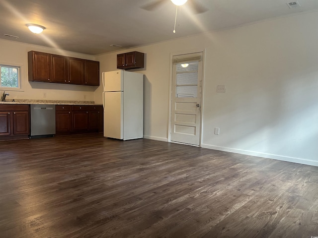 kitchen featuring dark wood-type flooring, dishwasher, sink, and white refrigerator