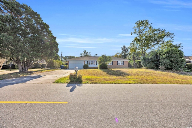 ranch-style house with a garage and a front yard