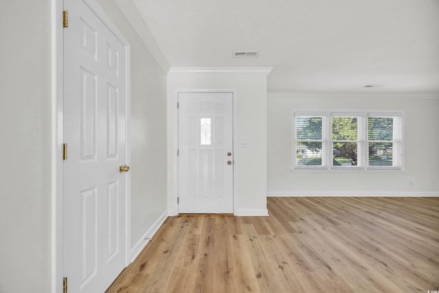 entryway featuring ornamental molding and light hardwood / wood-style floors