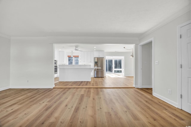 unfurnished living room featuring ornamental molding and light hardwood / wood-style floors