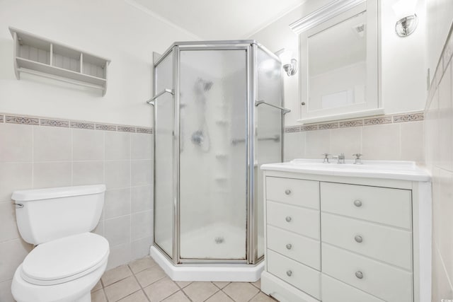 bathroom with a shower with shower door, tile patterned floors, and tile walls