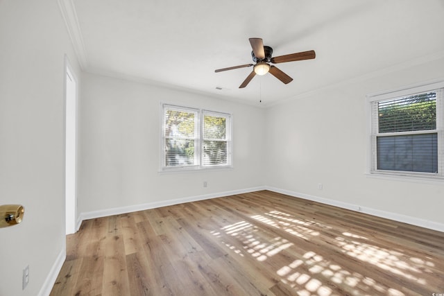 empty room featuring light wood-type flooring, ceiling fan, and crown molding