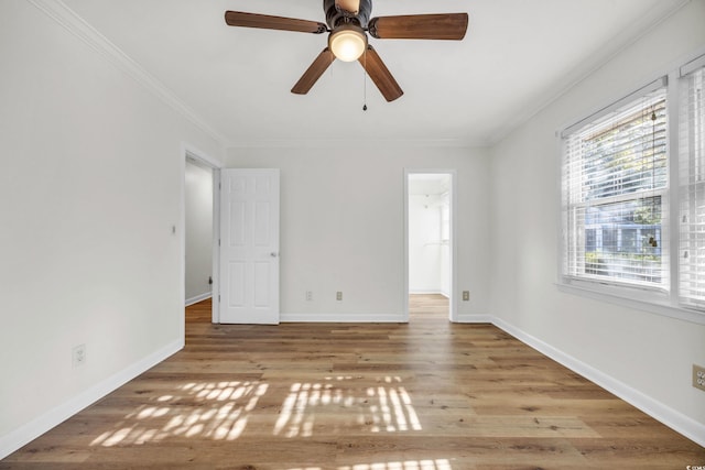 unfurnished room featuring light wood-type flooring, ceiling fan, and ornamental molding