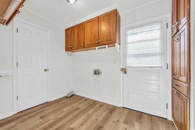 washroom with cabinets, hookup for a washing machine, light wood-type flooring, and ornamental molding