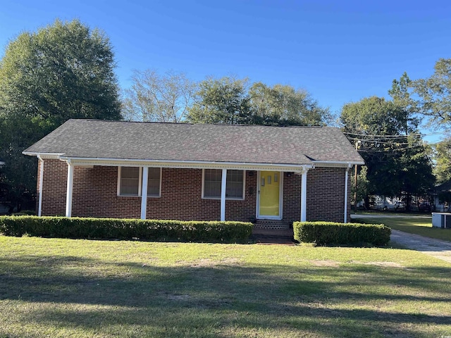 view of front of property with brick siding and a front yard