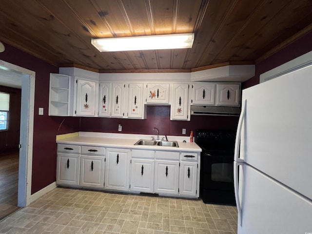 kitchen featuring black range with electric stovetop, a sink, under cabinet range hood, white cabinetry, and freestanding refrigerator