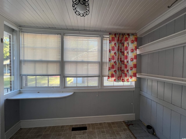 unfurnished sunroom with wood ceiling