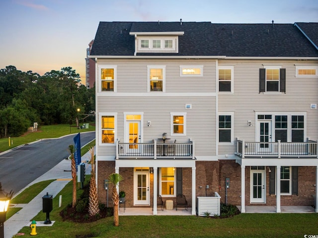 8479 Duke Pl Unit 34, Myrtle Beach, SC 29572 - back of property with brick siding, a lawn, a patio, and a balcony