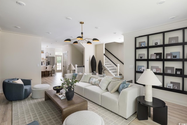 8479 Duke Pl Unit 34, Myrtle Beach, SC 29572 - living area featuring light wood-style floors, a chandelier, stairway, and crown molding