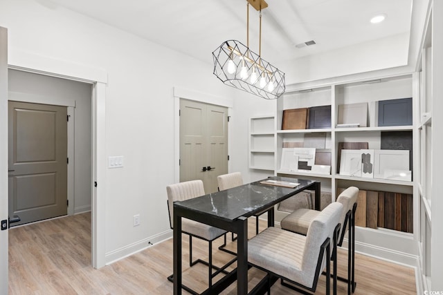 8479 Duke Pl Unit 34, Myrtle Beach, SC 29572 - dining room featuring light wood-style floors and a chandelier