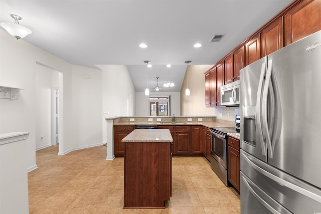 kitchen featuring sink, stainless steel appliances, kitchen peninsula, vaulted ceiling, and a kitchen island