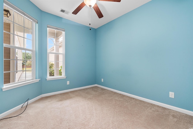 empty room with carpet flooring and ceiling fan