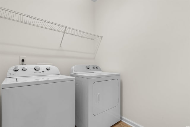 clothes washing area featuring independent washer and dryer