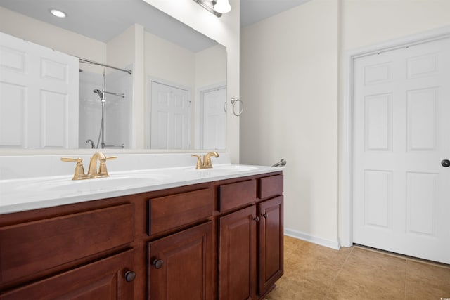 bathroom featuring vanity, tile patterned floors, and walk in shower