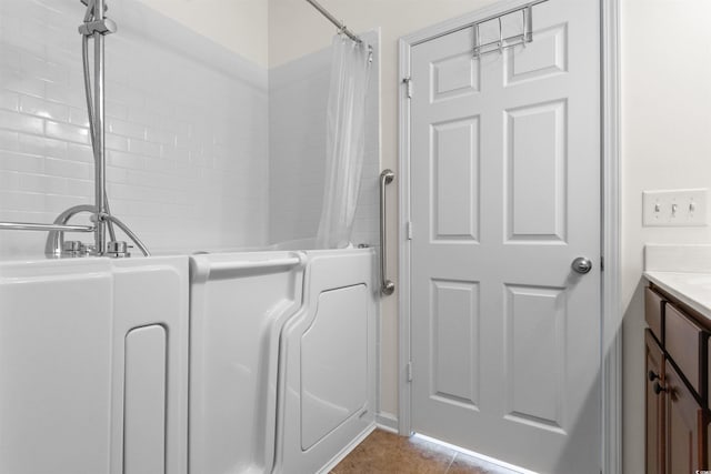 bathroom with tile patterned flooring, vanity, and shower / tub combo with curtain