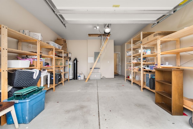 garage with a garage door opener and water heater