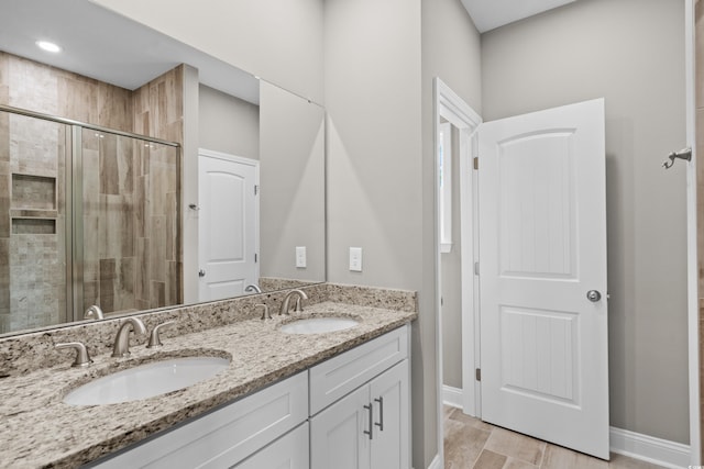428 Meadow View Ct, Longs, SC 29568 - bathroom with a shower stall, double vanity, and baseboards
