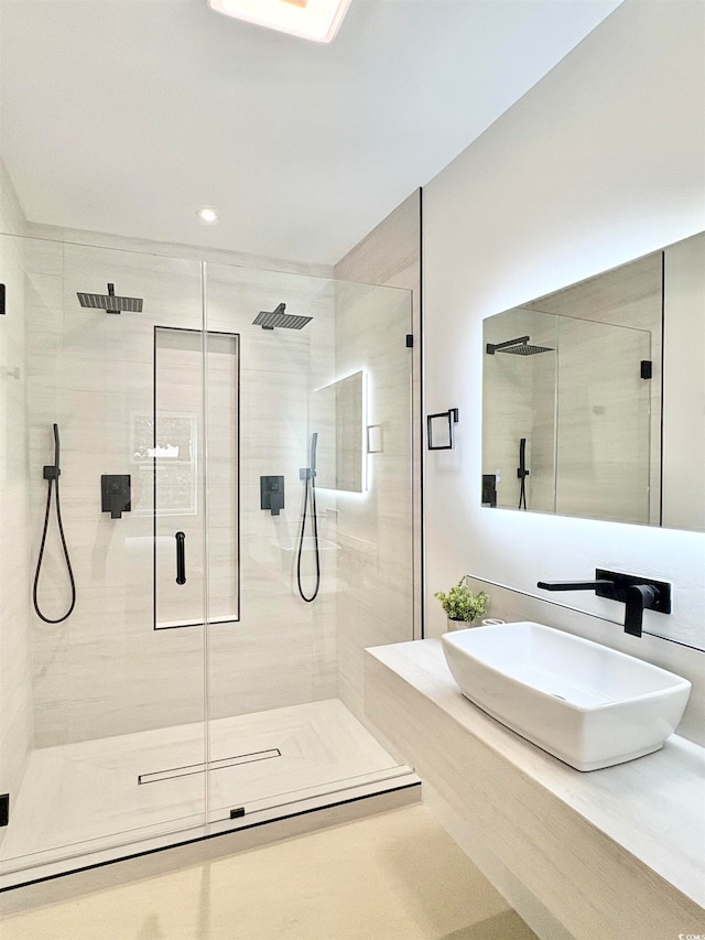 bathroom with an enclosed shower and sink