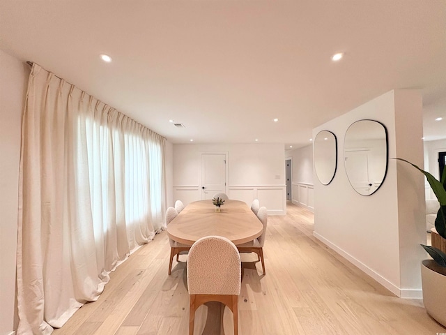 dining space with light hardwood / wood-style floors