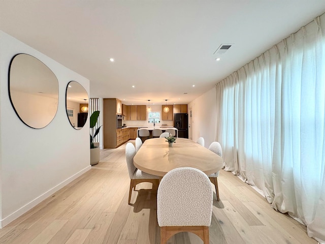 dining space with light hardwood / wood-style flooring