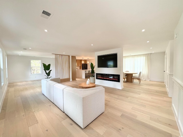 living room with light hardwood / wood-style flooring